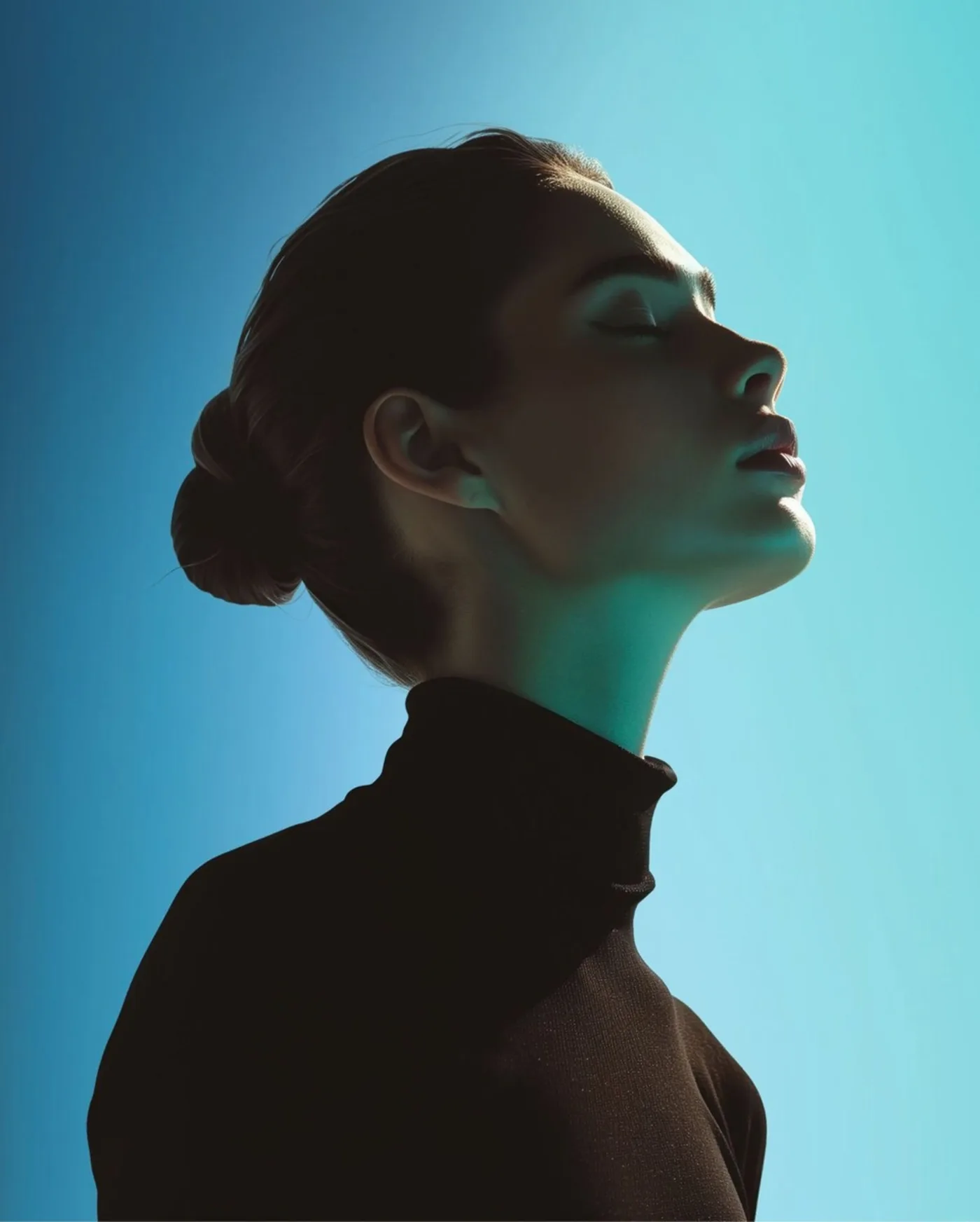 Serene woman in profile bathed in teal light, representing cellular vitality and longevity